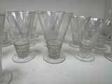 a lot of glasses sitting on a table together