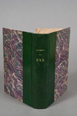 an open book with a green cover sitting on top of a table