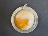 an egg in a bowl on a black table