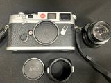a camera and a lens on a black table