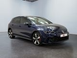 a blue volkswagen golf gtr parked in a showroom