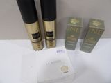 three bottles of perfume and a box on a white surface