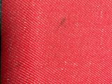a close up of a red and black bag on a table