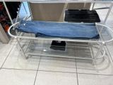 a metal bench with a blue towel on it in a store