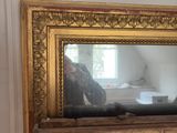 a picture of a cat sitting on top of a picture frame