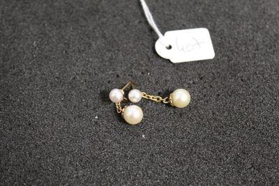 gros plan d'une paire de boucles d'oreilles sur une surface noire