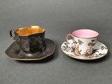 two cups and saucers are sitting on a table