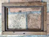 a picture of an old picture frame on a brick wall