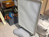 a white board sitting on a stand in a room