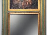 a painting on the wall above a mirror in a room