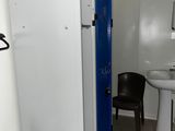 a small bathroom with a sink and a refrigerator in it