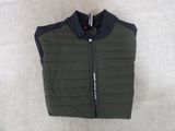 the vest is green and black with a zipper on the front