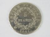 a close up of a coin on a white surface with a white background