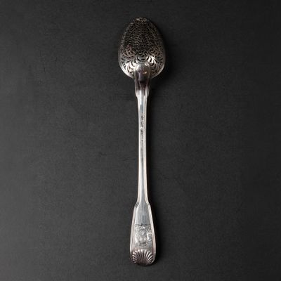 a spoon that is sitting on a black surface