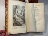 a hand holding an open book with a picture on it