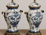 two blue and white vases sitting on top of a table next to each other