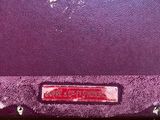 a red sign on the side of a purple wall