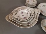 a lot of plates and bowls sitting on a table