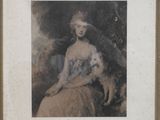 une vieille photo représentant une femme assise sur une chaise avec un chat