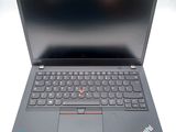 a close up of a laptop with a keyboard on a white surface