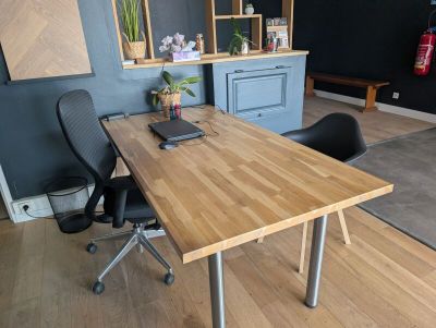 a wooden table with a laptop on it in a room