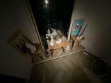 a small table and chairs in a room with a mirror