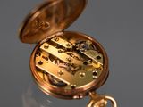 a close up of a pocket watch on a table