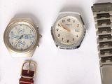 many different types of watches on a white surface