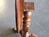 a small wooden table with a mirror on top of it