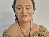 a figurine of a woman wearing a purple dress