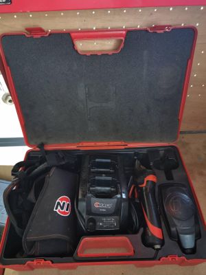 an open tool case with tools in it sitting on a table
