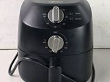 an image of a black air fryer sitting on a counter