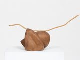 a wooden sculpture of a mouse on top of a white box