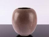 a brown vase sitting on a black table