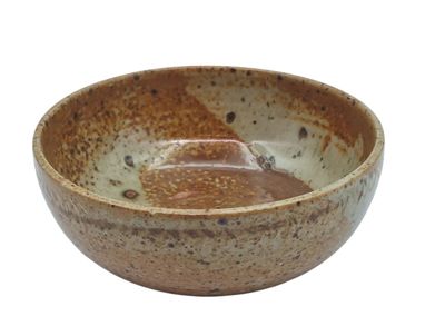 a brown and white bowl with a spoon in it