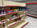 many shelves in the store that have different types of food on them