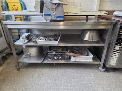 a kitchen with a stove, sink, and dishwasher in it