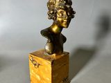pair of bronze busts of a woman on a marble base