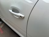 a close up of a car door handle on the side of the road