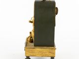 an image of a small clock on a wooden stand on a white surface