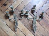 three candles that are sitting on a wooden floor