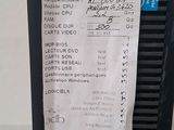 a close up of a computer on a table with a receipt attached to it