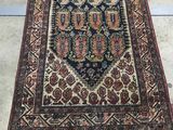 an oriental rug with a blue and red design on a white floor