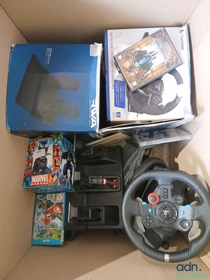 a box with a steering wheel, a game controller, a game and a box of games
