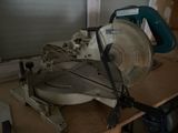 someone is using a circular saw to cut a piece of wood