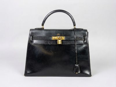 a black leather handbag on a white background