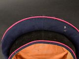 a blue hat with a pink band on top of it