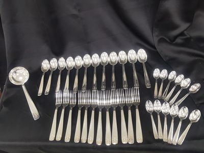 a lot of silver spoons and spoons on the table