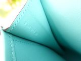 a close up of a blue purse with a zipper