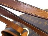 close up of a brown and tan bag with a strap on it